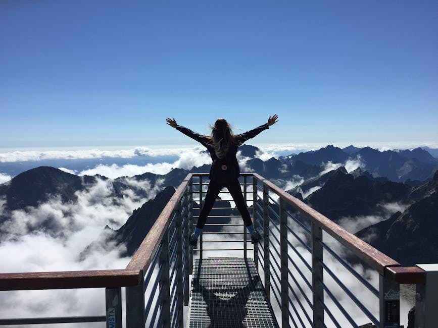 A woman stands on a viewing platform in Vysoké Tatry, Slovakia